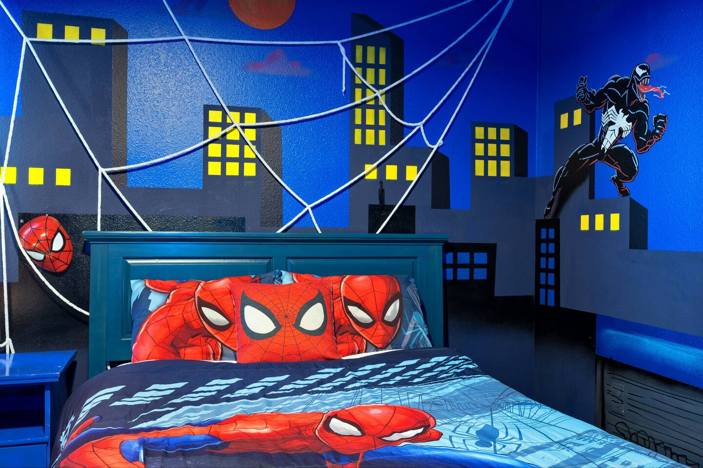 Spider-Man bedroom with hand-painted city skyline mural and rope web canopy