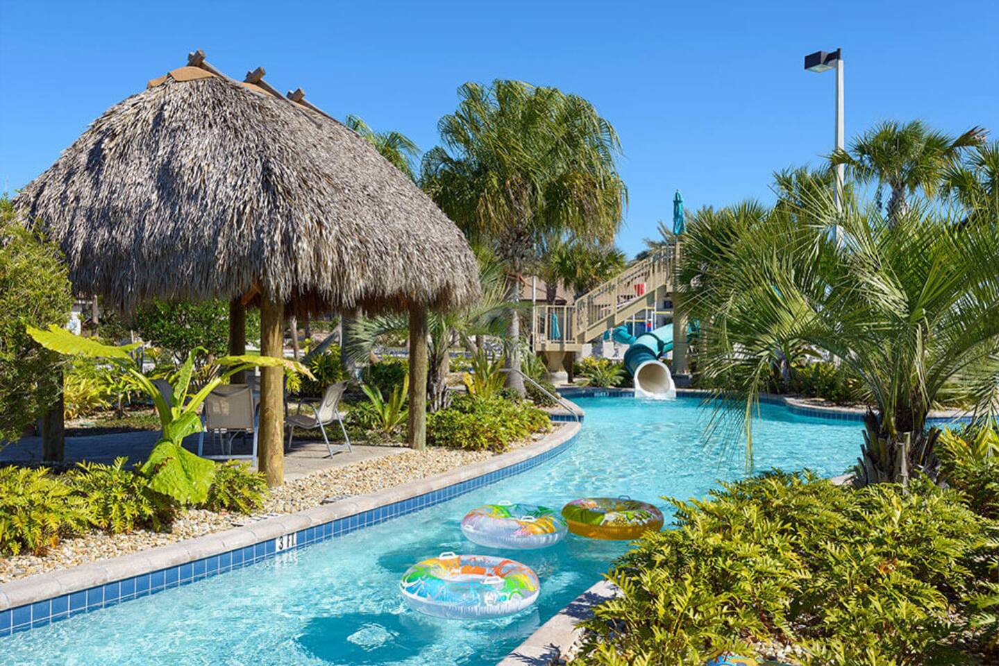 Resort lazy river with tiki huts and tube floats