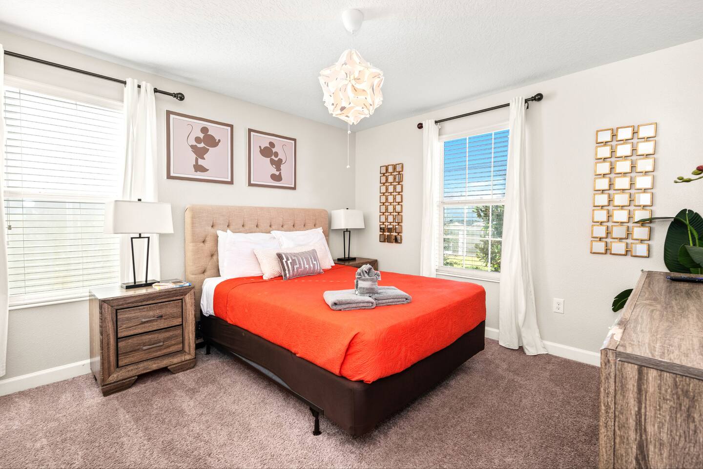 Mickey and Minnie-accented bedroom with plush king bed and dual nightstands
