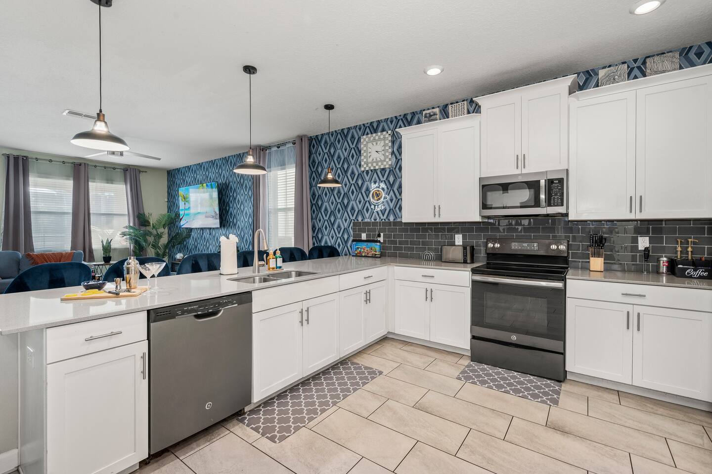 Kitchen breakfast bar flowing into the open living and dining space