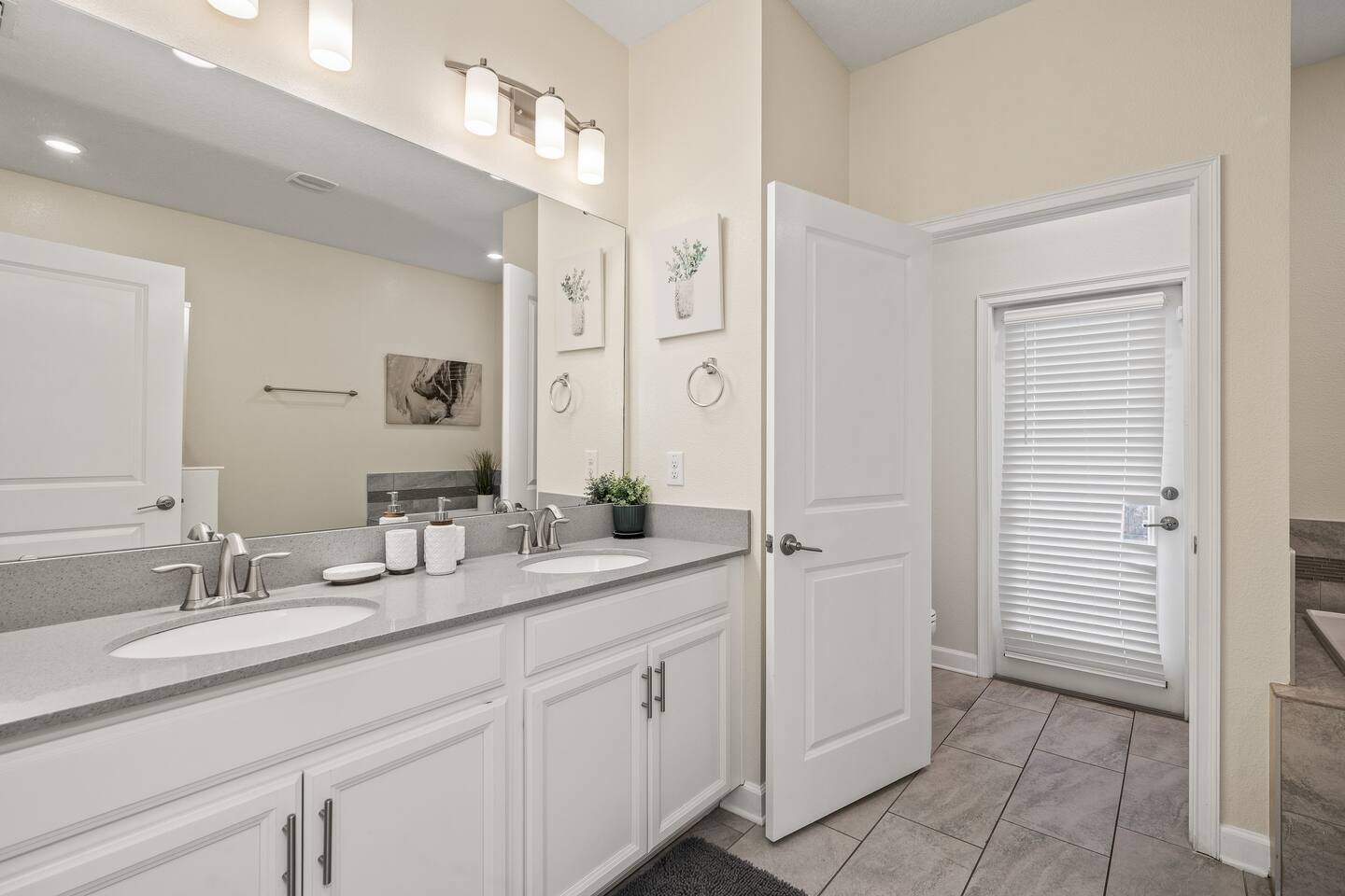 Double-vanity bathroom with quartz counters and ample storage