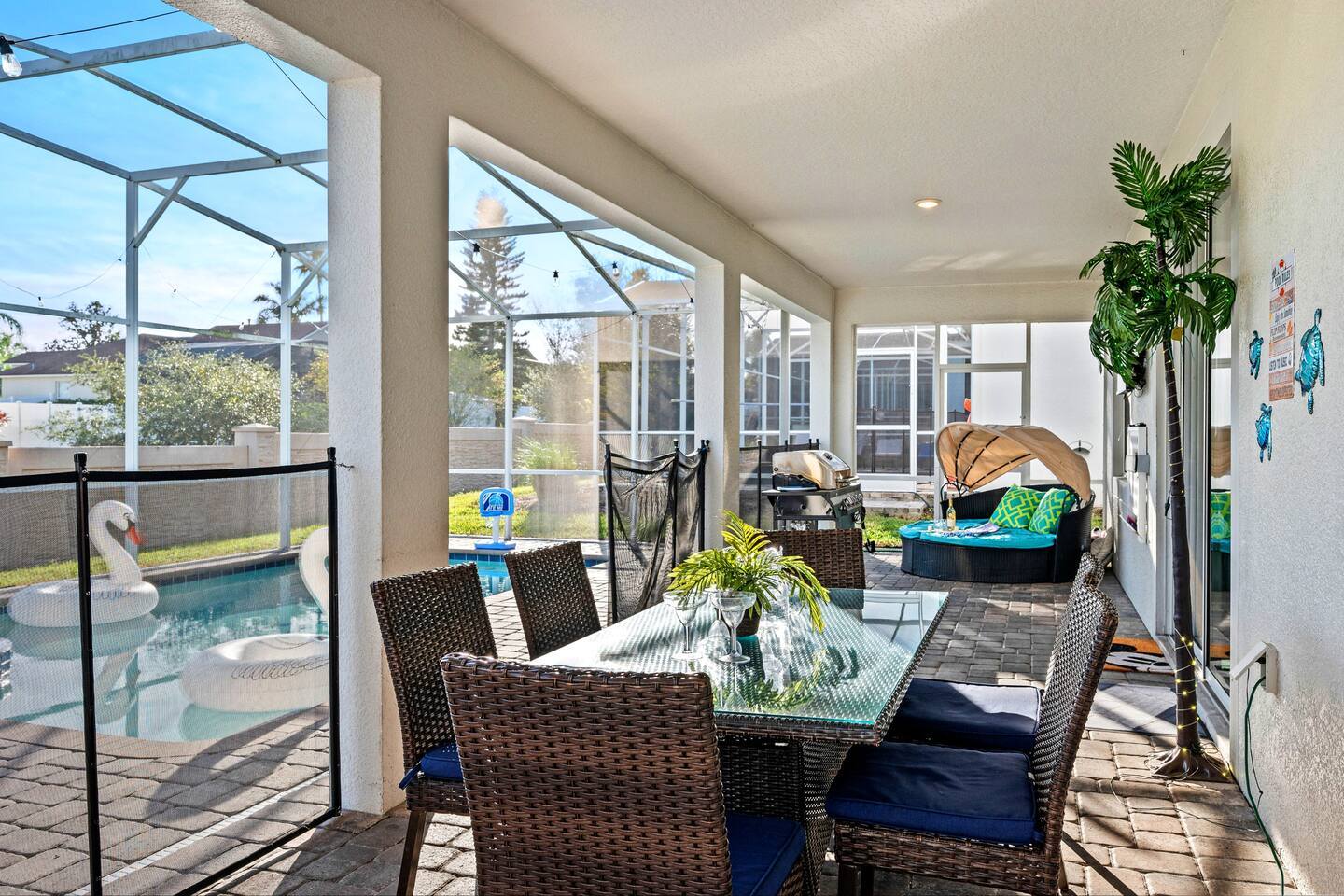Screened lanai with alfresco dining table beside the private pool