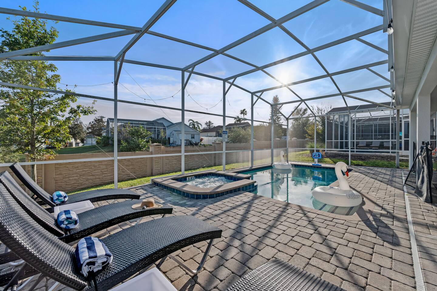 Private screened pool and spa with sun loungers and swan floats