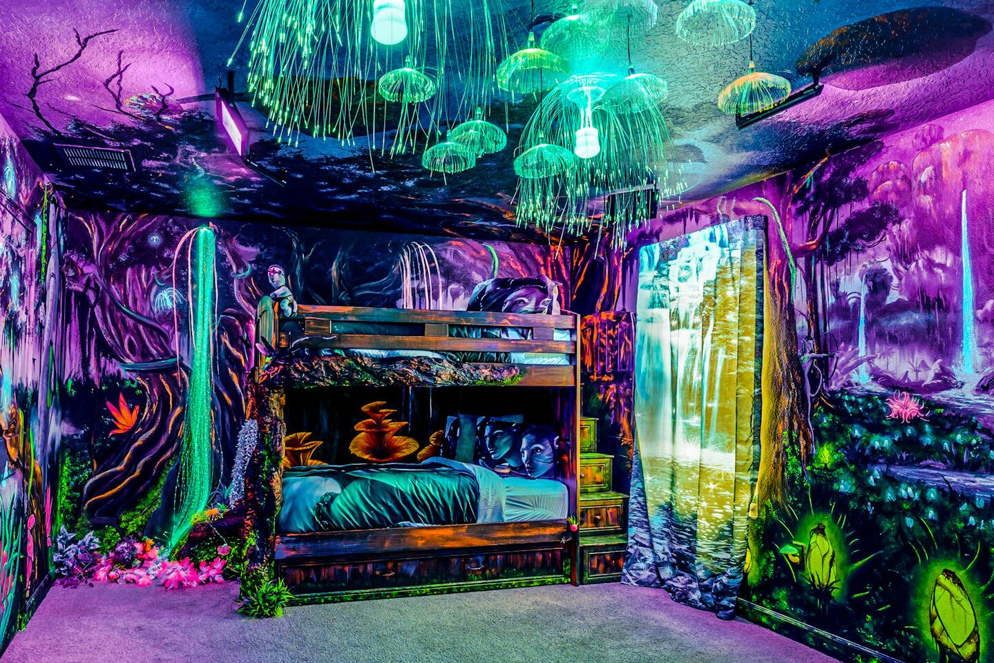 Glowing jellyfish ceiling canopy over themed bunk beds in the Avatar blacklight 