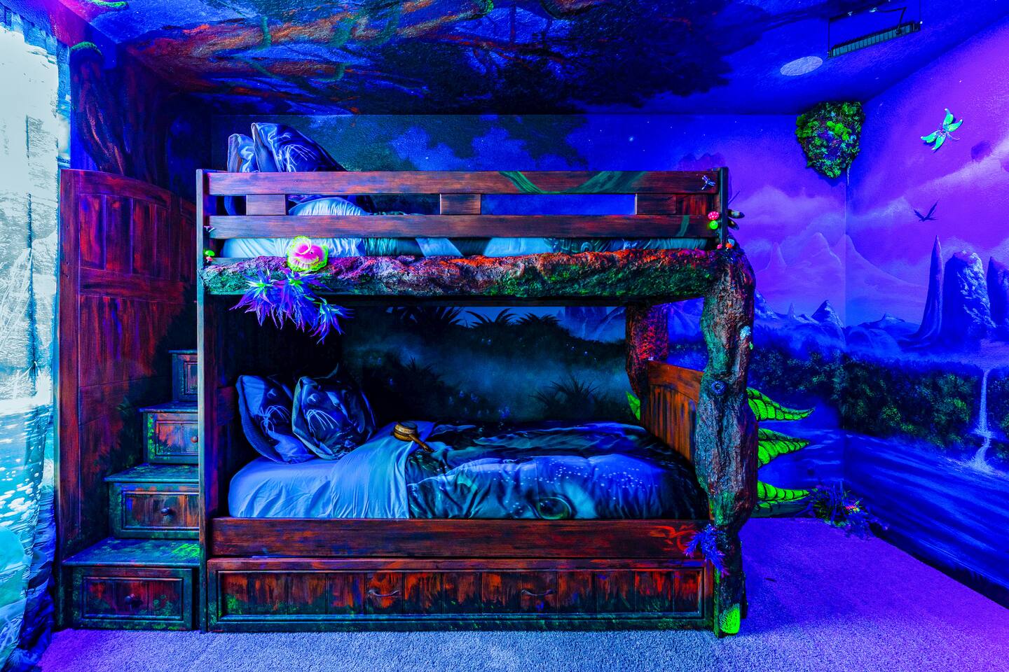 Full-over-full bunk with storage-step stairs wrapped in hand-painted bioluminesc
