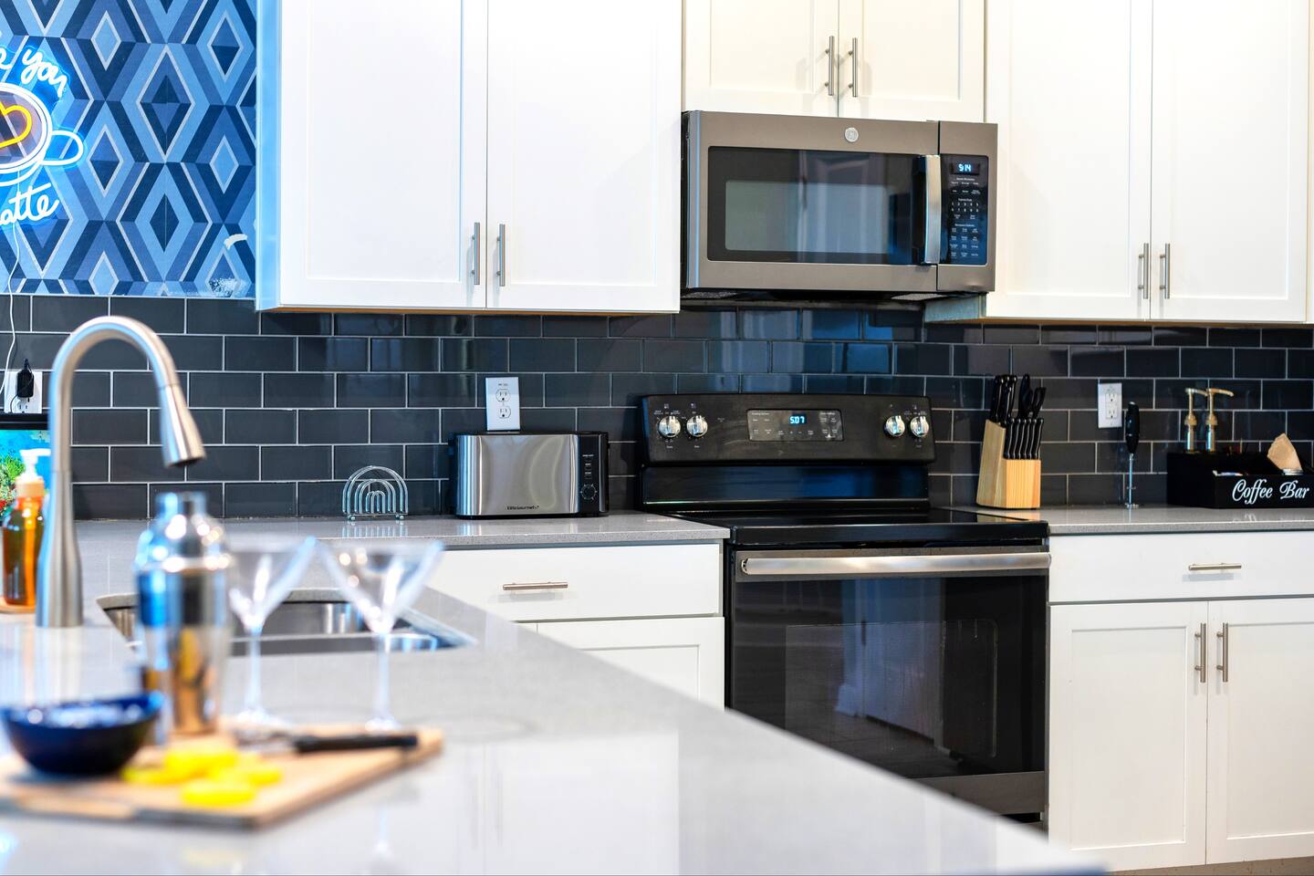 Fully equipped kitchen with stainless appliances, subway-tile backsplash, and co