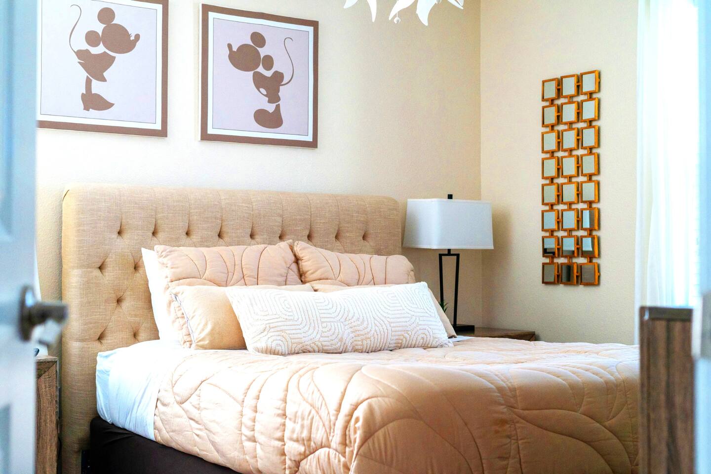 Cozy queen bedroom with subtle Mickey and Minnie silhouette artwork