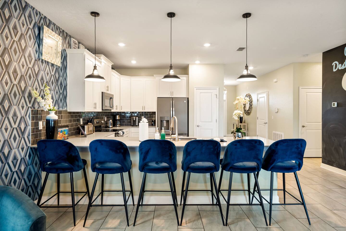 Fully equipped kitchen with stainless appliances and island seating for six