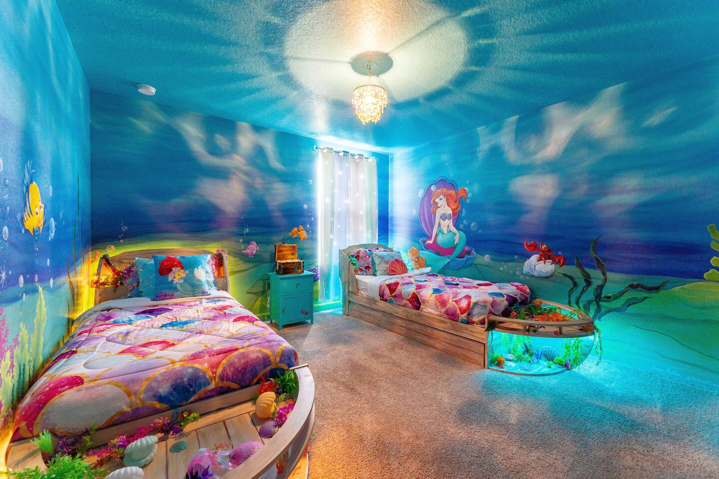 Both boat beds and glowing reef displays in the mermaid room