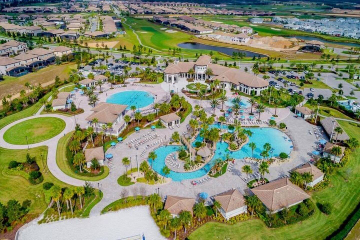 Aerial view of the resort clubhouse, pools, and lazy river available to guests