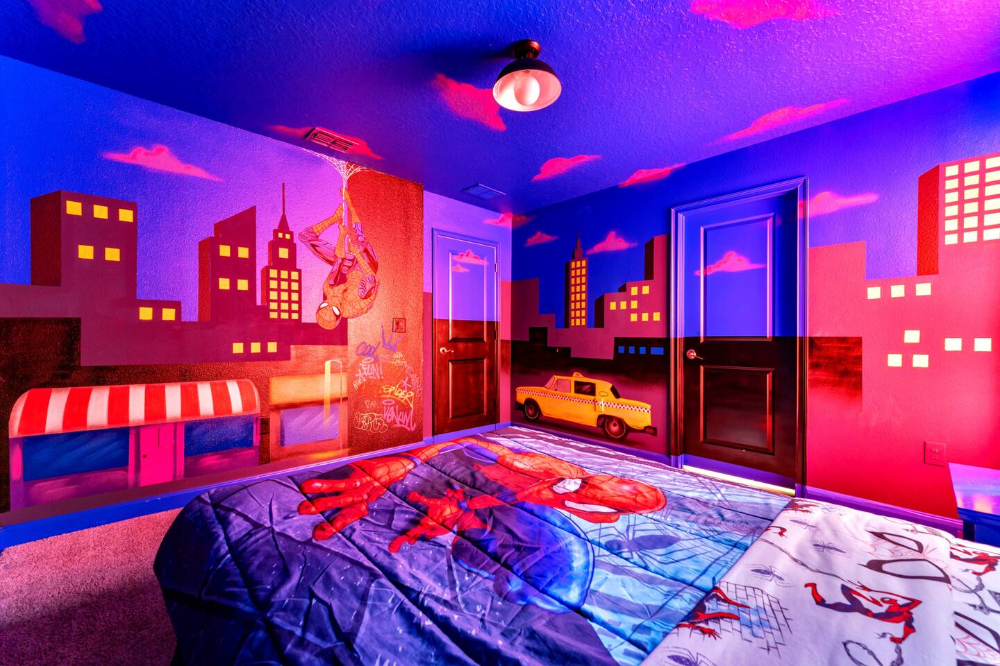 Hand-painted cityscape mural with taxi and web-crawler details wrapping the Spid