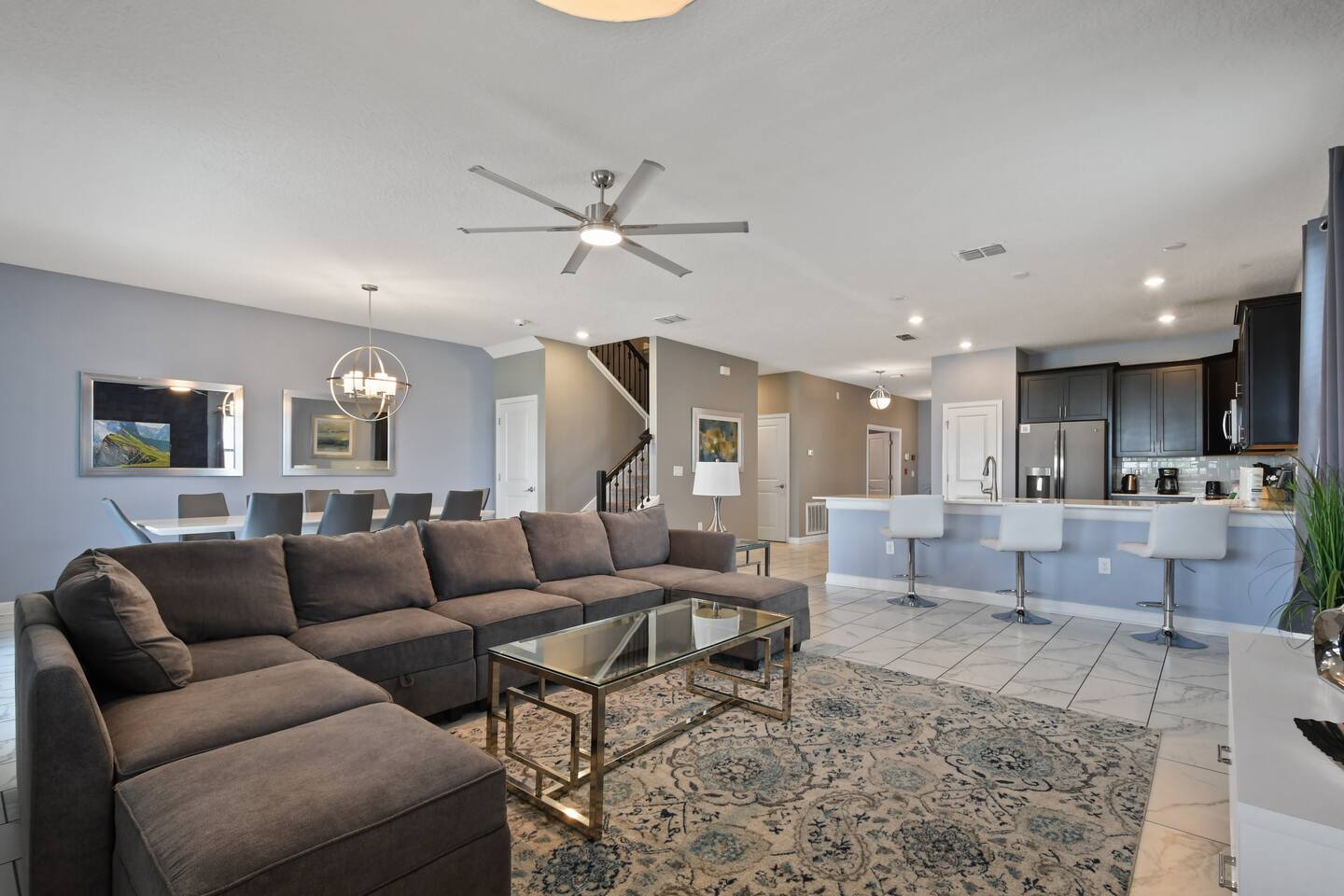 Open-plan great room with sectional, breakfast bar, and kitchen
