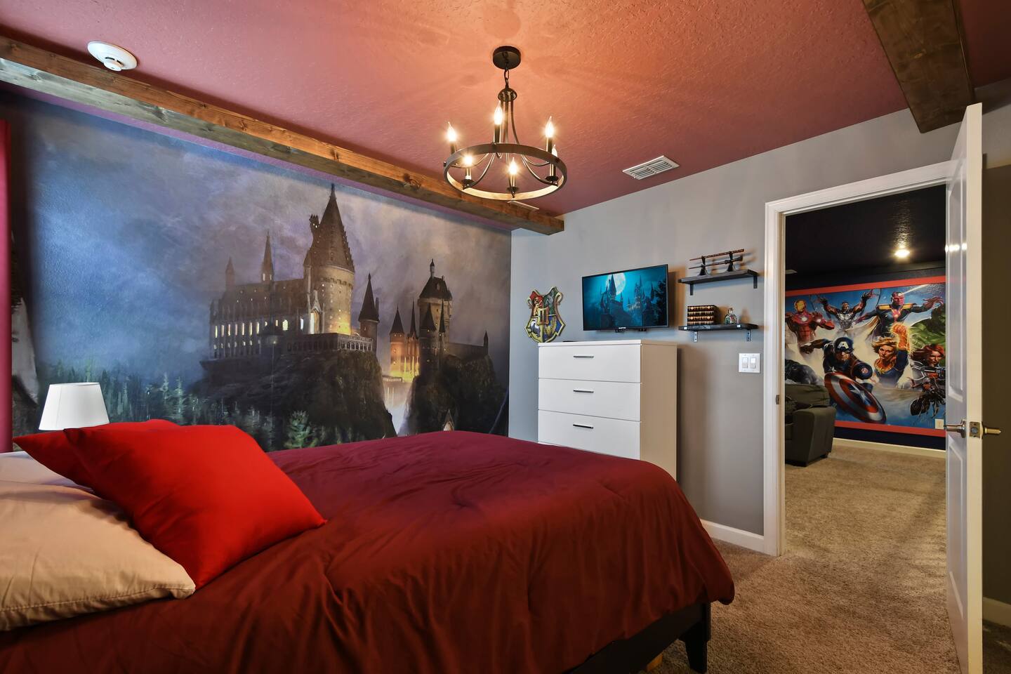 Harry Potter room with castle mural, chandelier, and TV