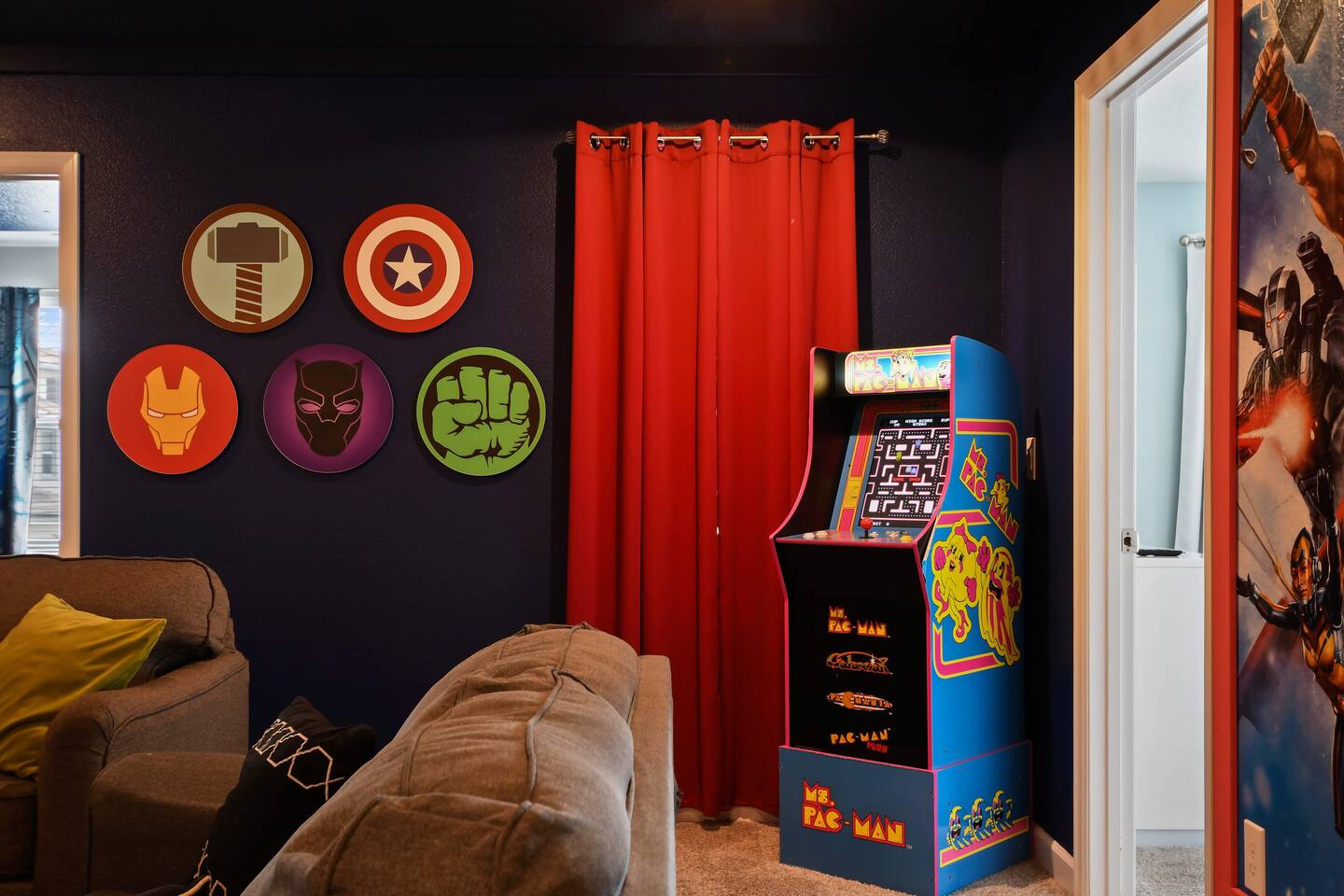 Arcade cabinet with Avengers wall art
