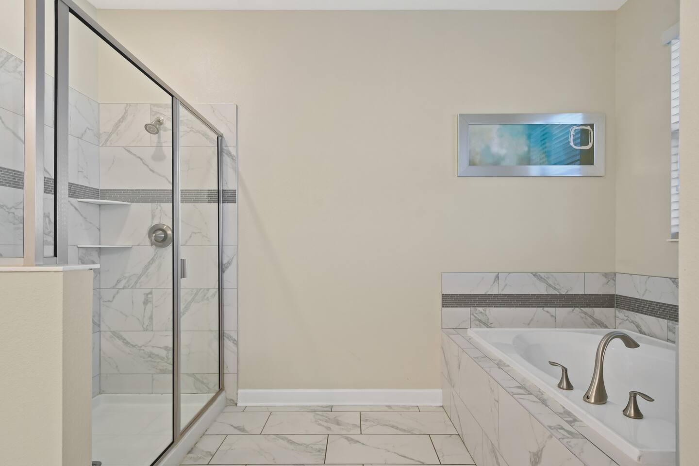 Bathroom with glass walk-in shower and soaking tub