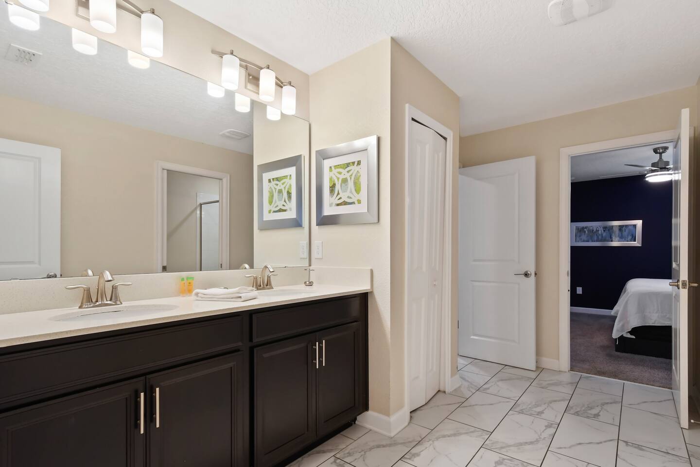 Bathroom with double-sink vanity and tile floors