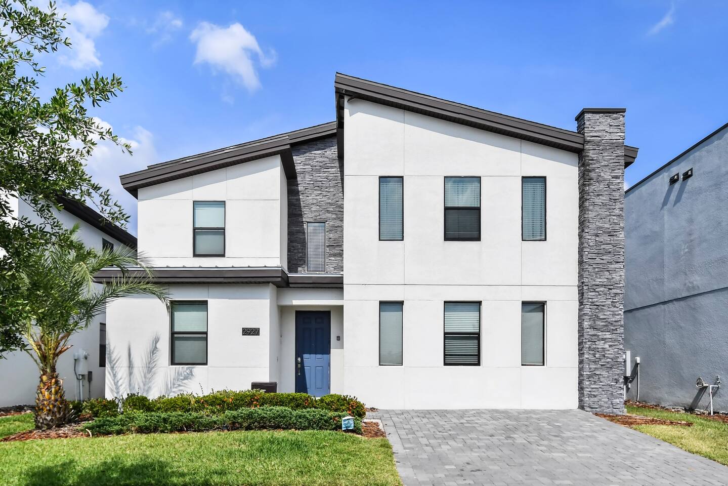 Front exterior of the two-story home with stone accents