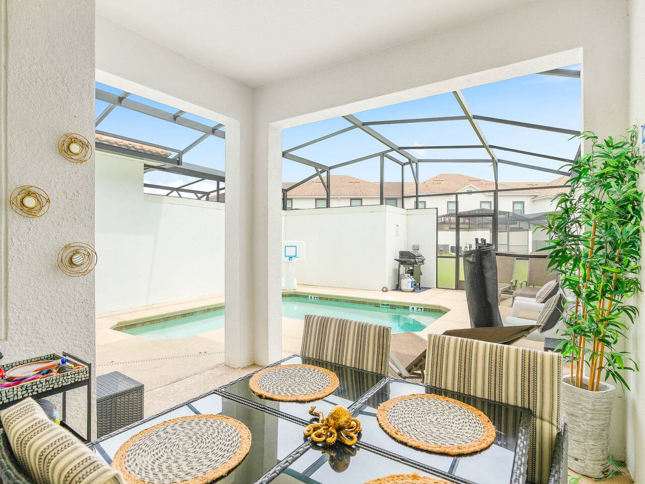 Outdoor Dining Oasis: Enjoy meals with a view by the sparkling pool in this invi