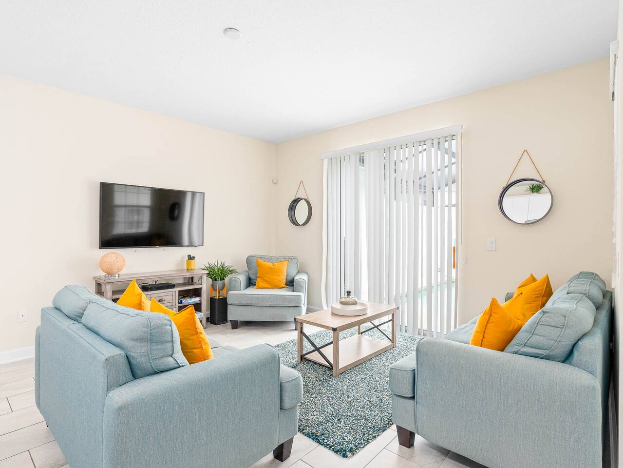 Bright and inviting space with plush seating and a view of the sunny pool area!