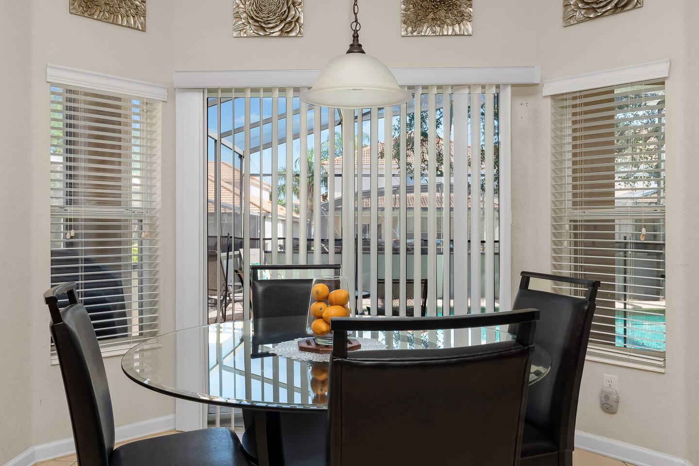 Bright space with a glass table, perfect for family meals and sunny pool views!