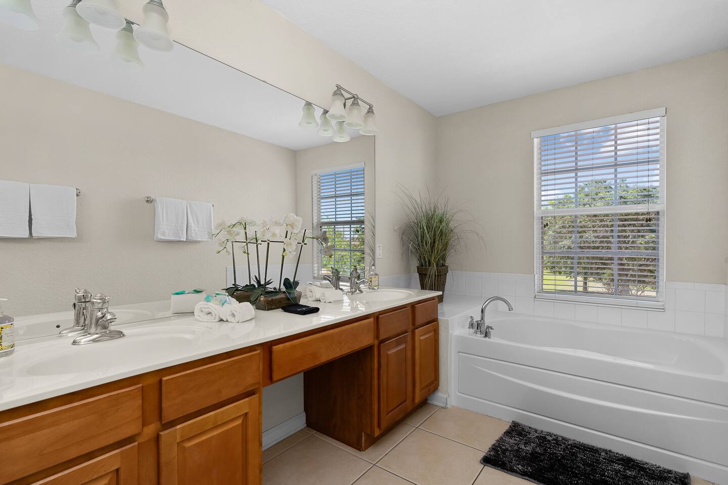 Dual sinks, a soaking tub, and sunny garden views