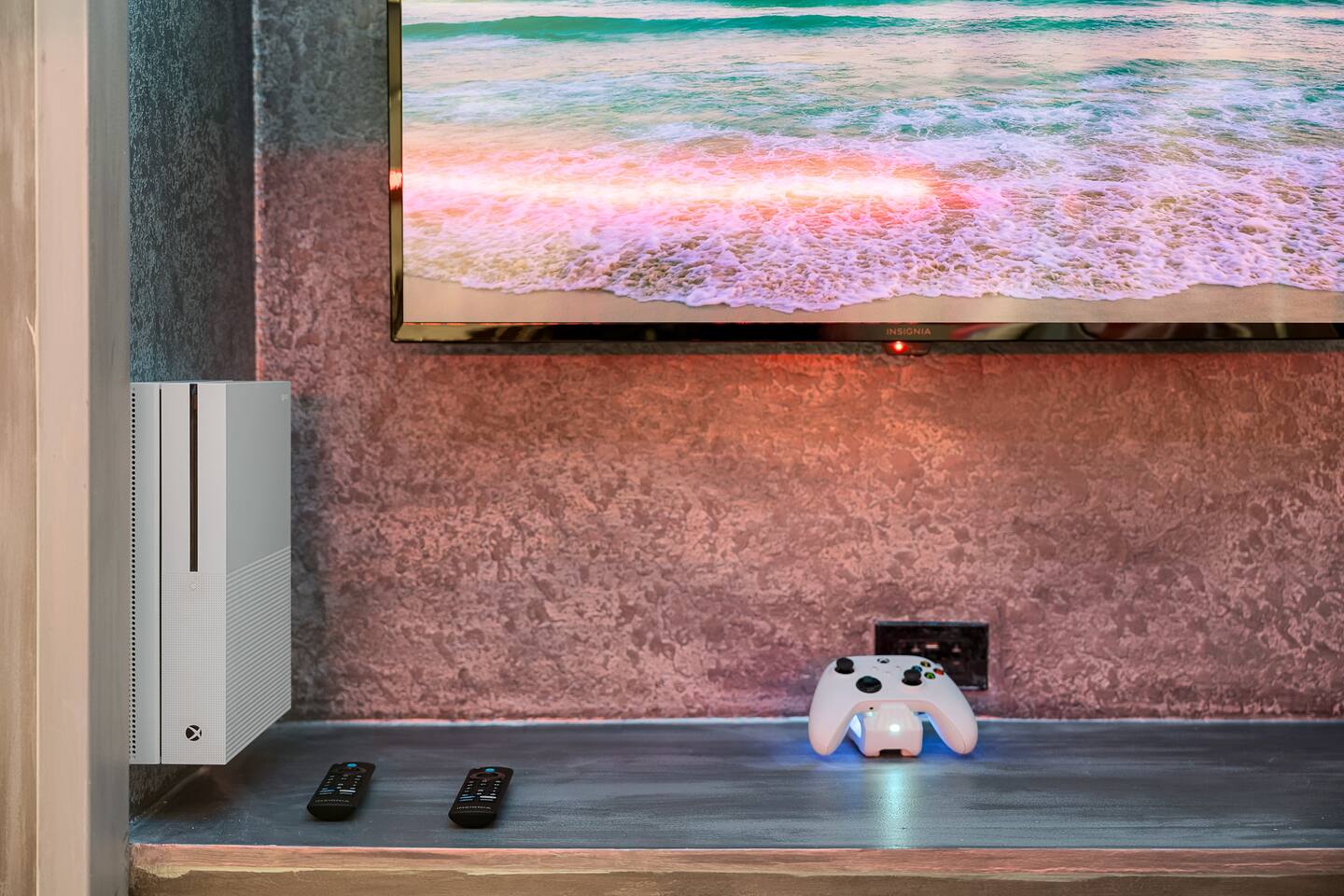 Entertainment Nook: Enjoy gaming on a sleek console, complemented by a stunning 