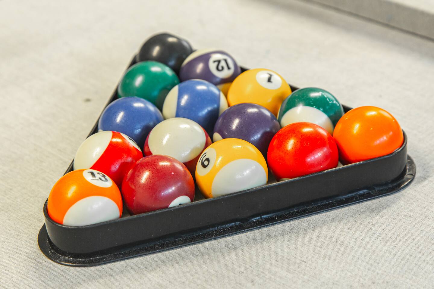 Racked billiard balls on the pool table.