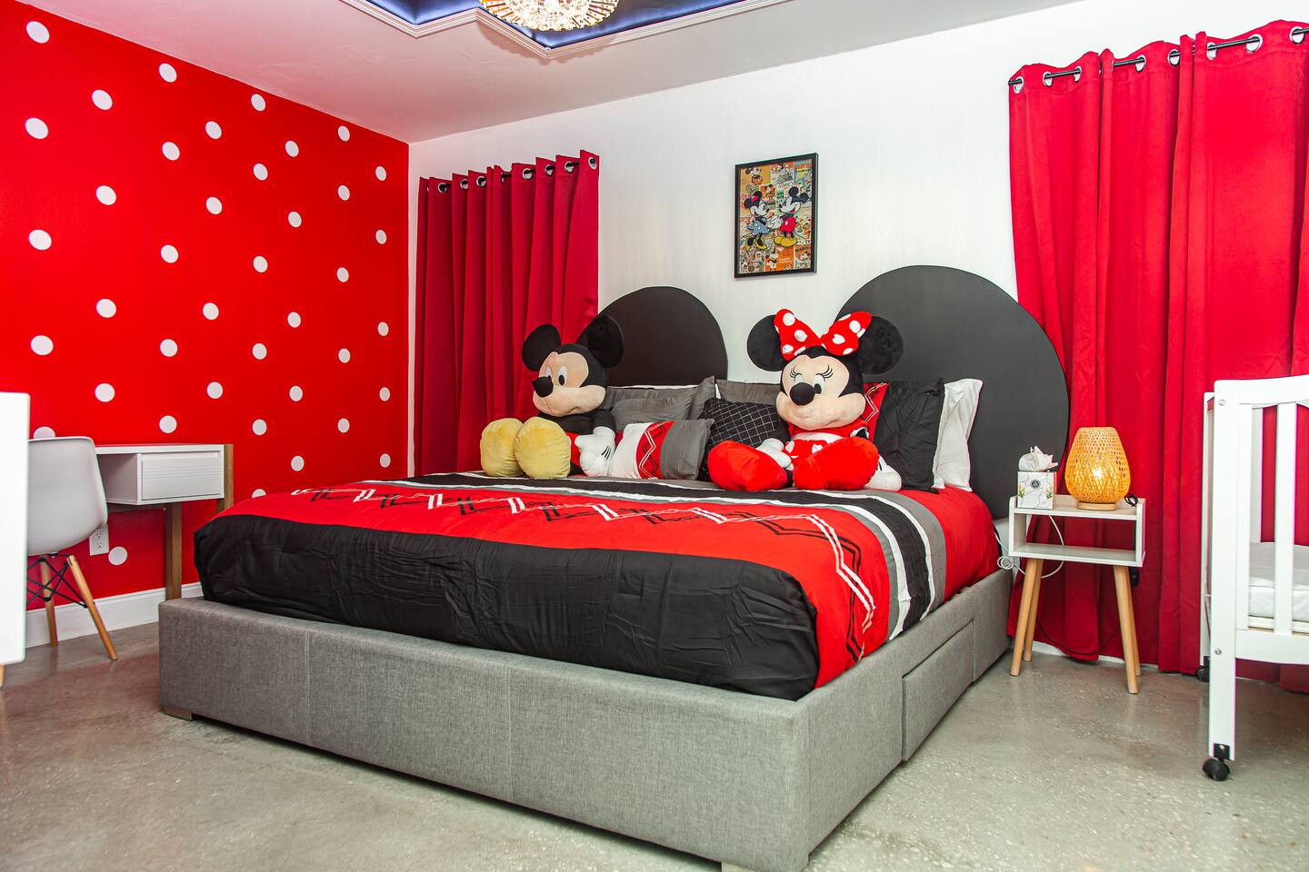 Mickey master bedroom king bed with mouse-ear headboards and plush toys.