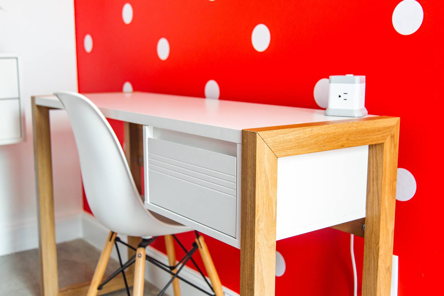 Desk and chair against the polka-dot accent wall in the master bedroom.