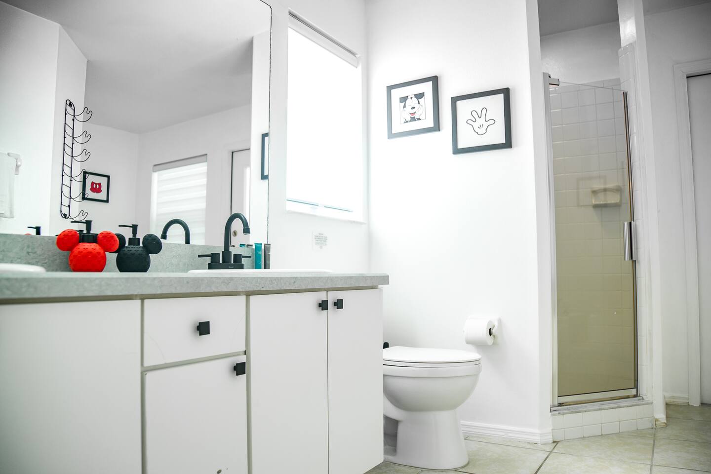 Bathroom with a single vanity, toilet, and glass shower stall.