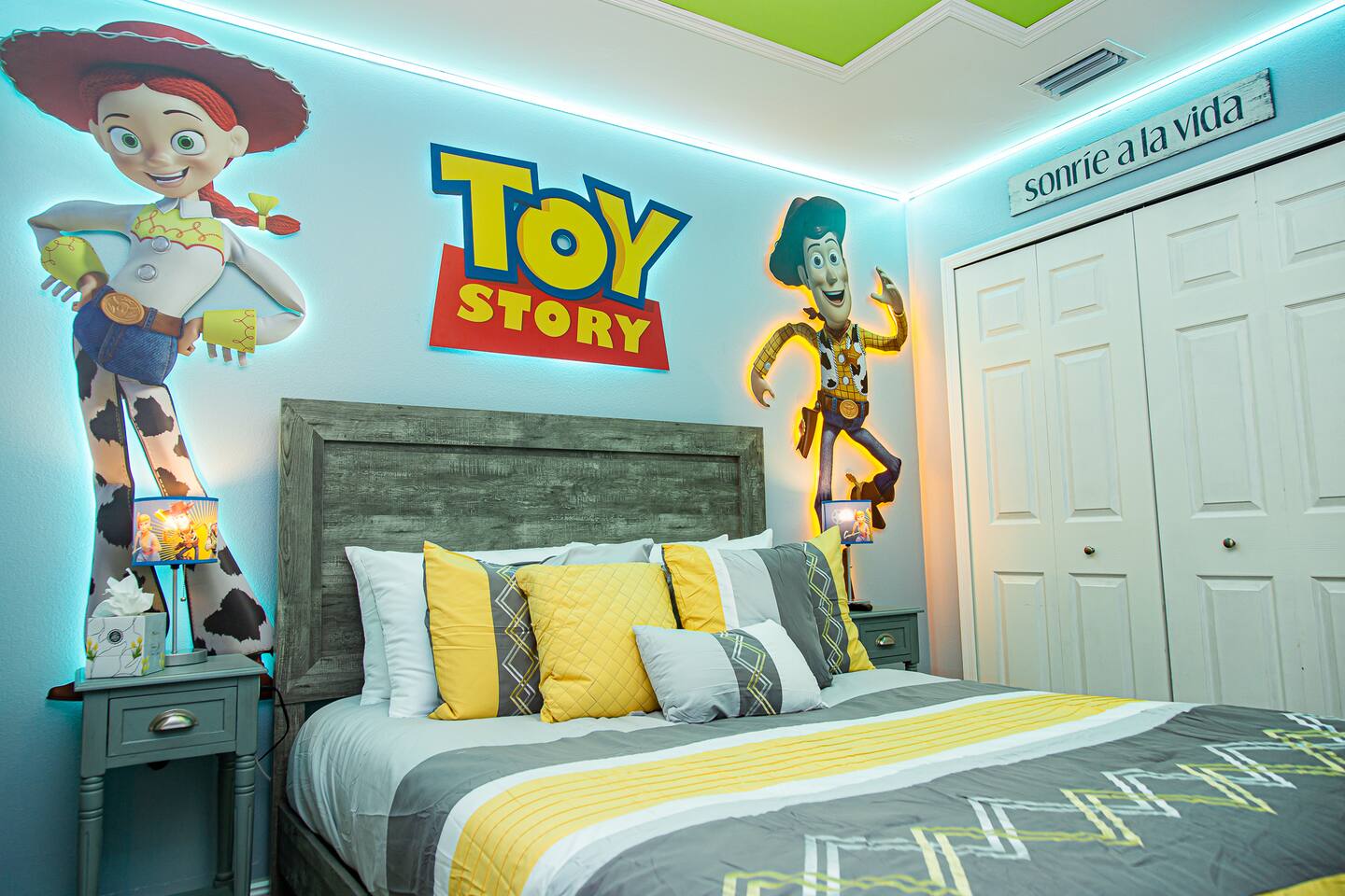 Toy Story bedroom with a queen bed and Toy Story wall decals.