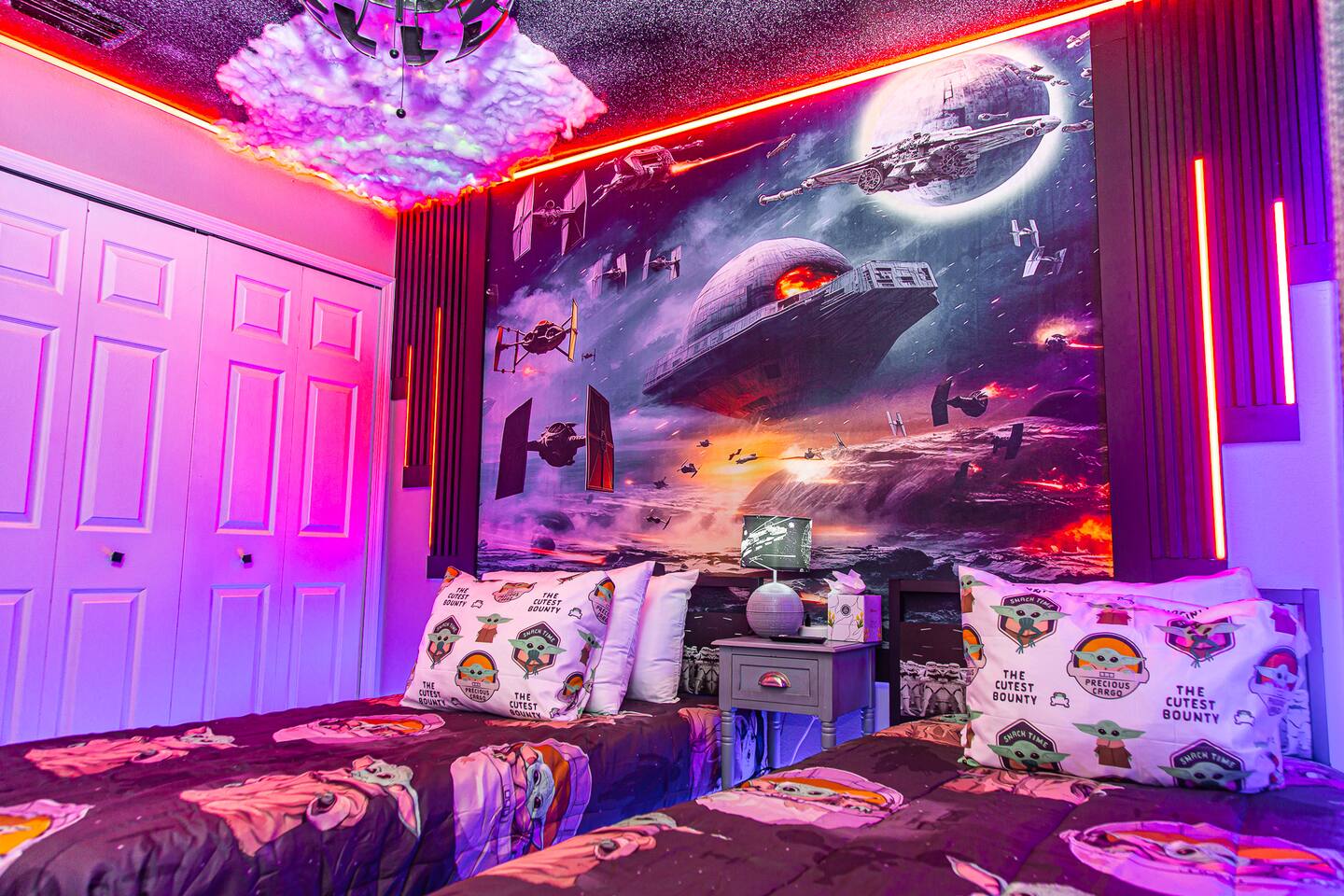Star Wars bedroom twin beds beneath a space-battle mural.
