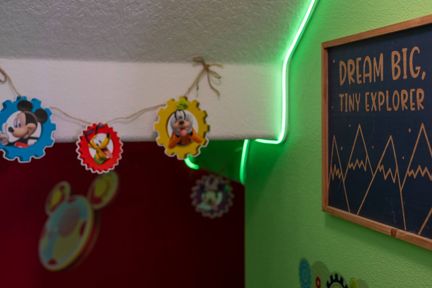 Dream big, tiny explorer — hand-strung character garland in the toddler hideout.