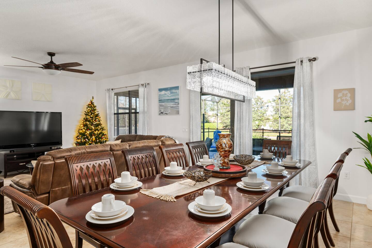 The dining table seats the crowd, with the living room and lanai steps away.