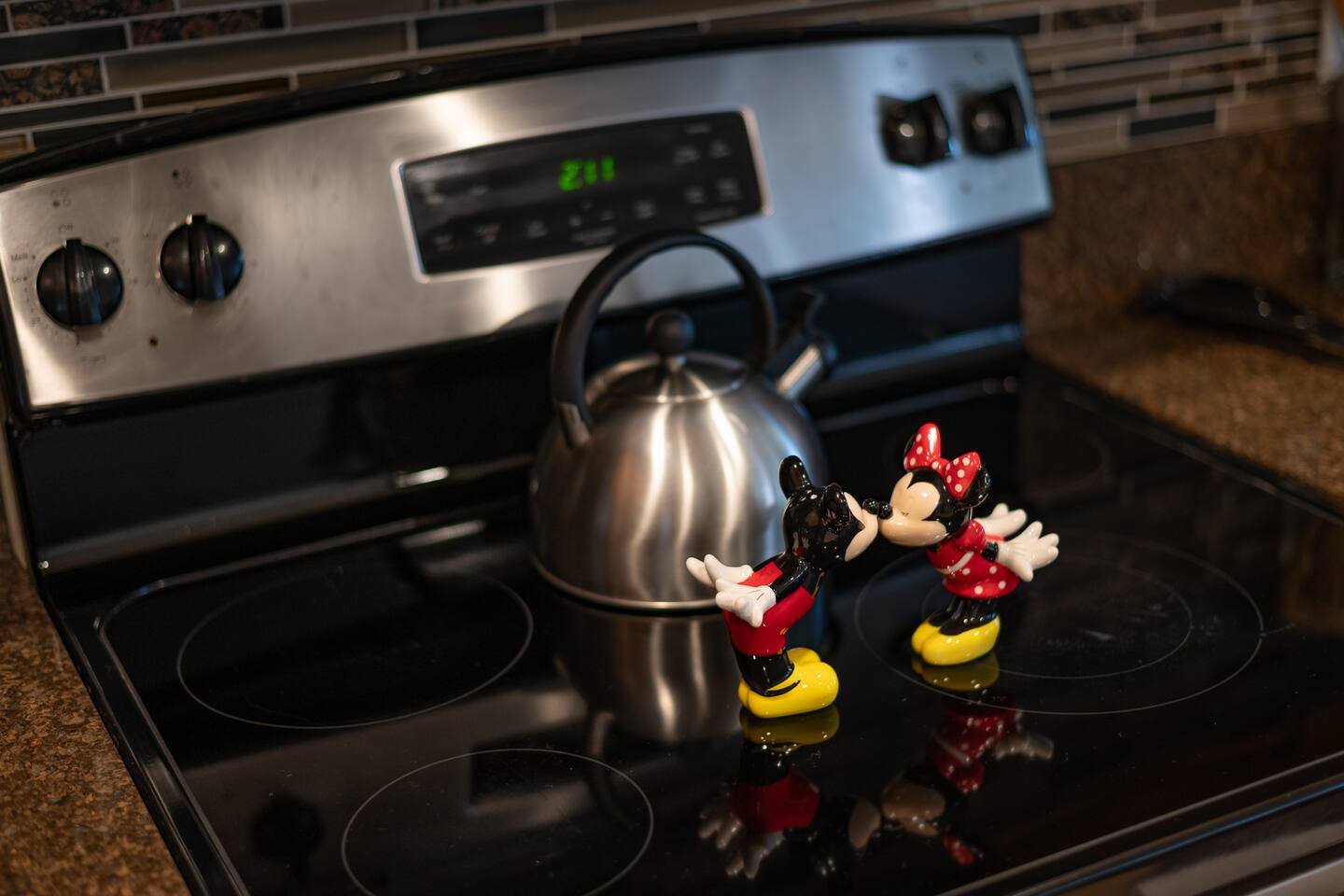 Mickey and Minnie shakers keep watch over the stove — small touches everywhere.