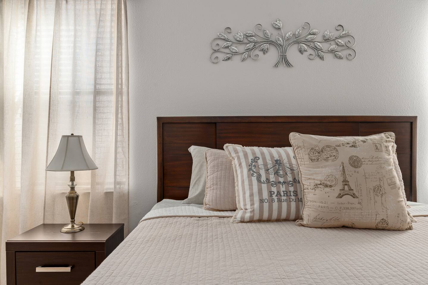 Paris-inspired accent pillows dress the king bed in the downstairs suite.