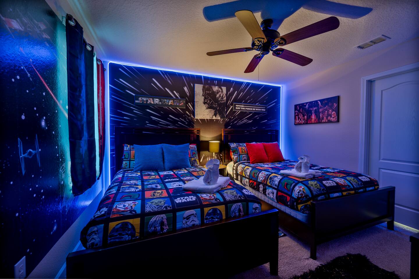 The Star Wars room: two full/queen beds under a hyperspace mural with LED lighti
