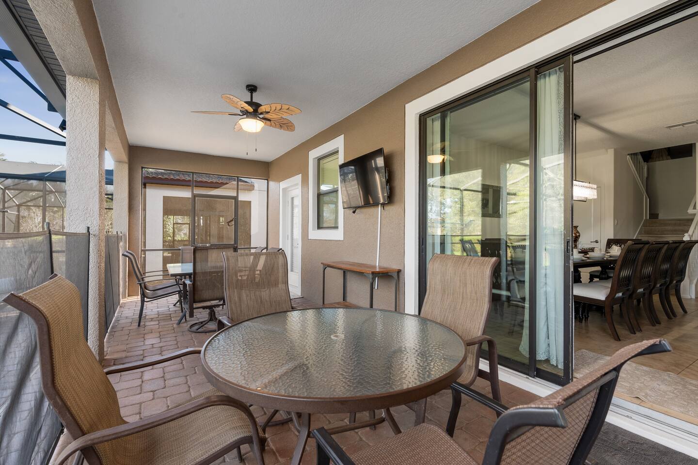 Al fresco dining on the lanai with outdoor TV, steps from the main living area.