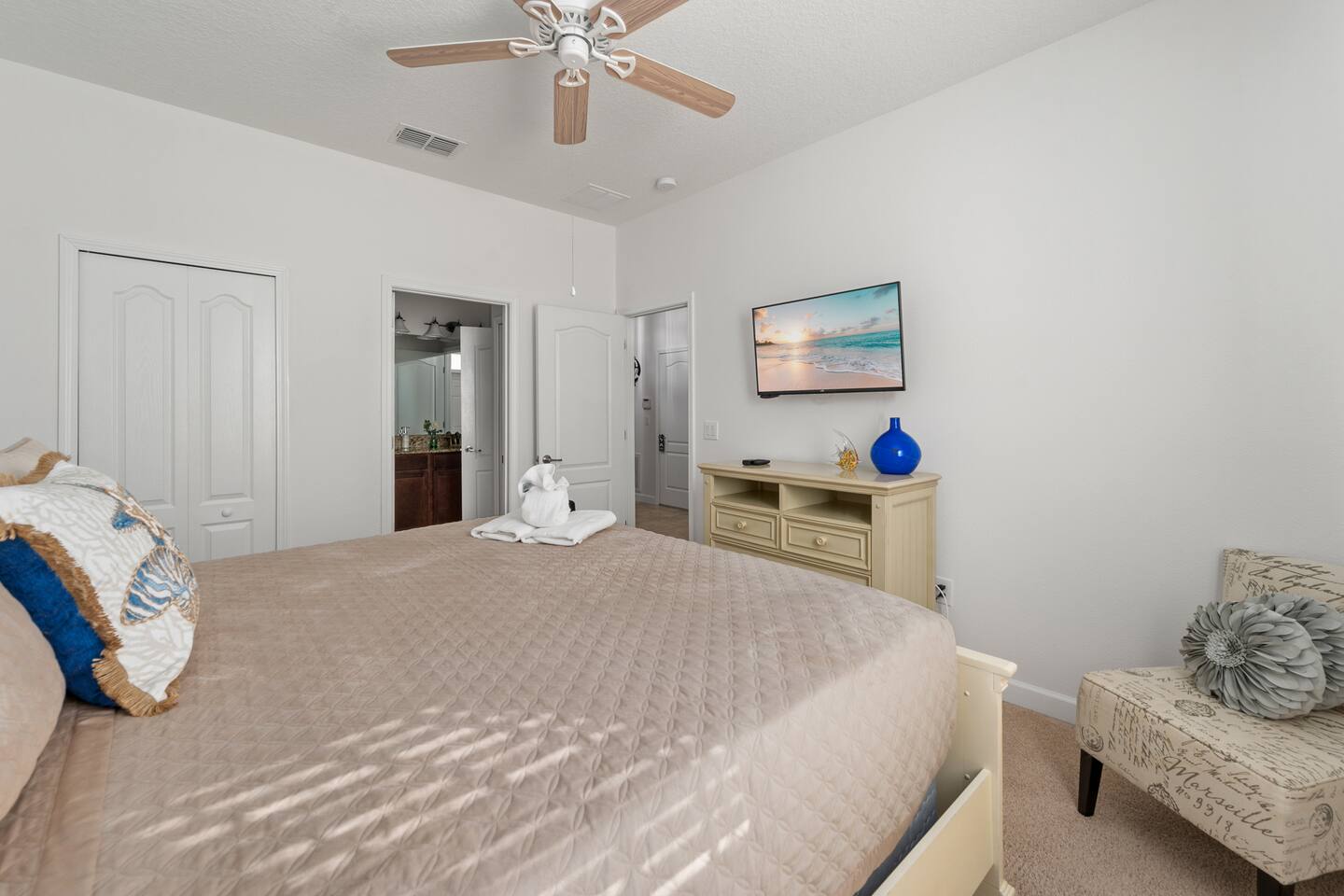 The coastal king suite's TV wall and private access to its bath.