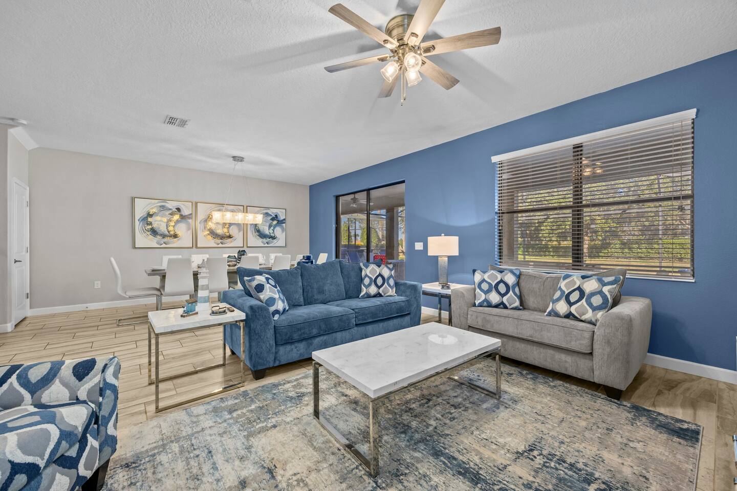 Family room seating area with a blue sofa and gray loveseat around a marble coff