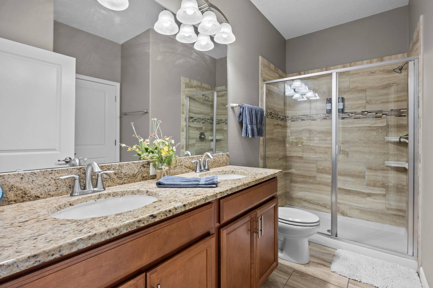 Ensuite bathroom with granite double vanity and glass-door walk-in shower