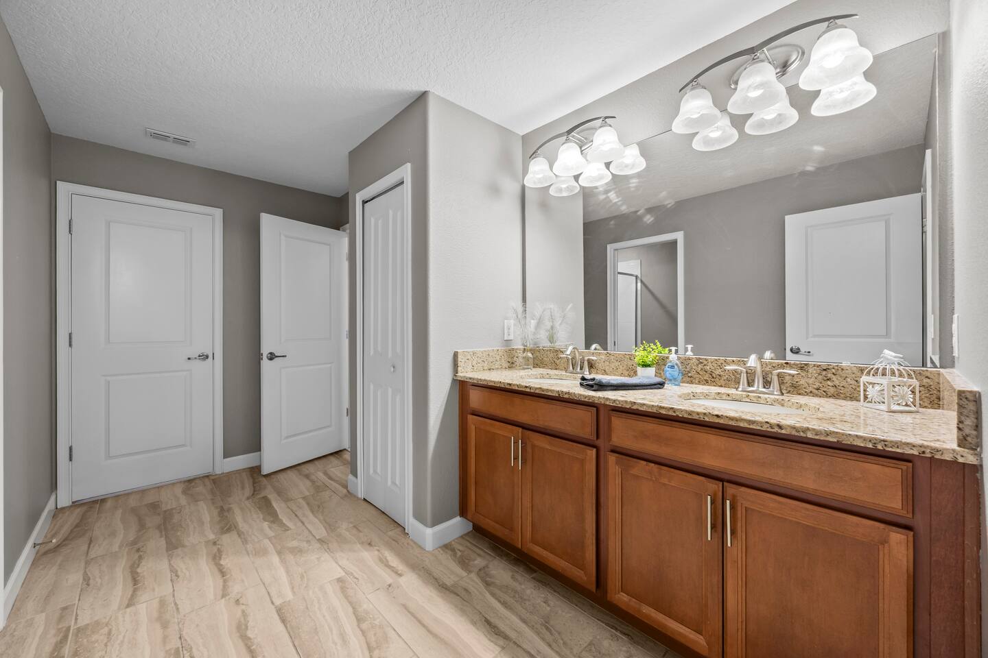 Upstairs bathroom with granite double vanity and wood cabinetry