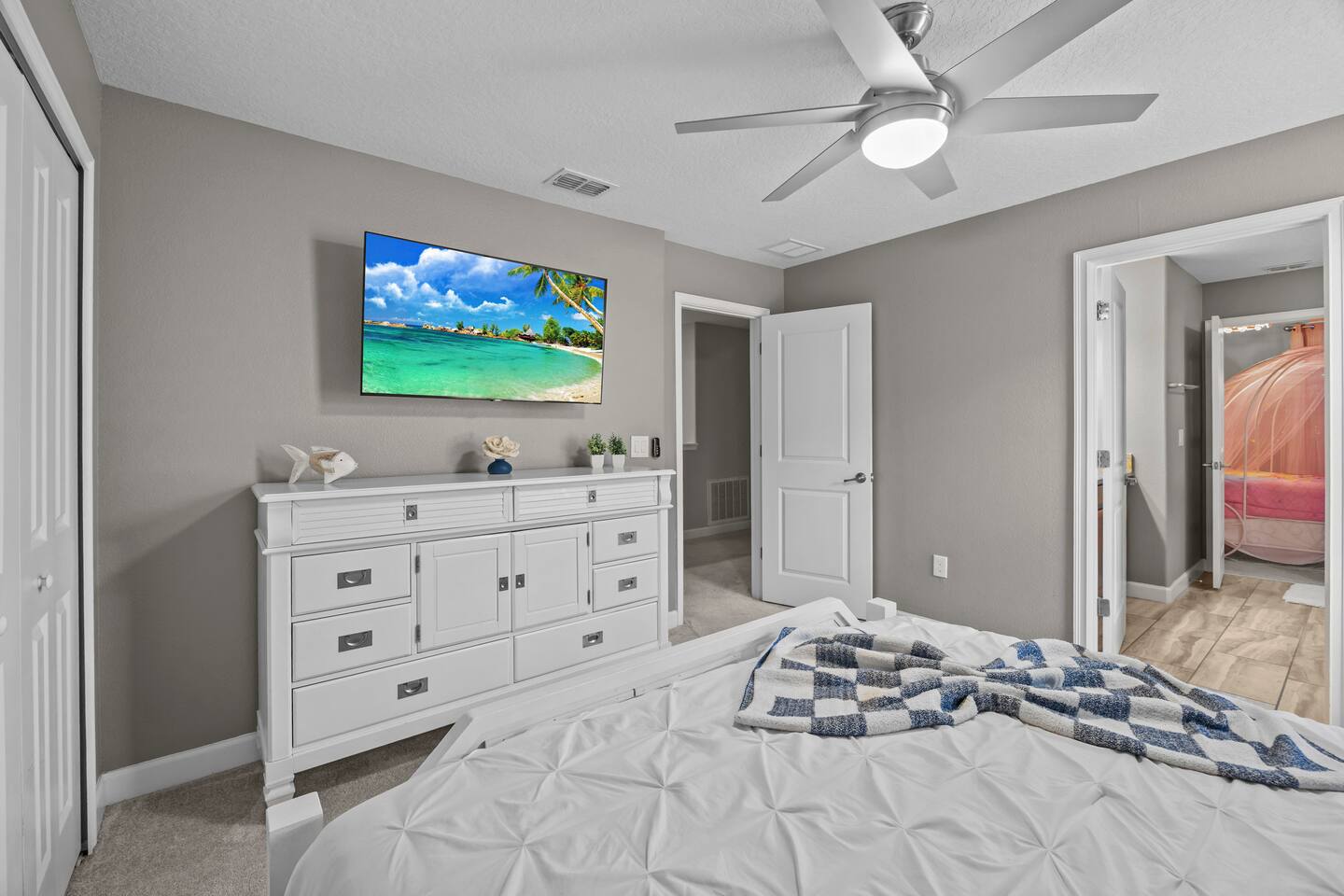 Same white bedroom showing the dresser and hallway view toward the princess room
