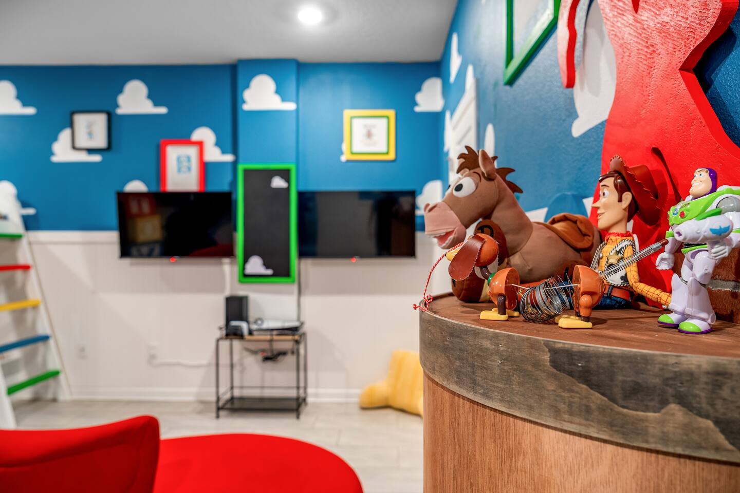 Toy Story character toys and TVs in themed play bedroom