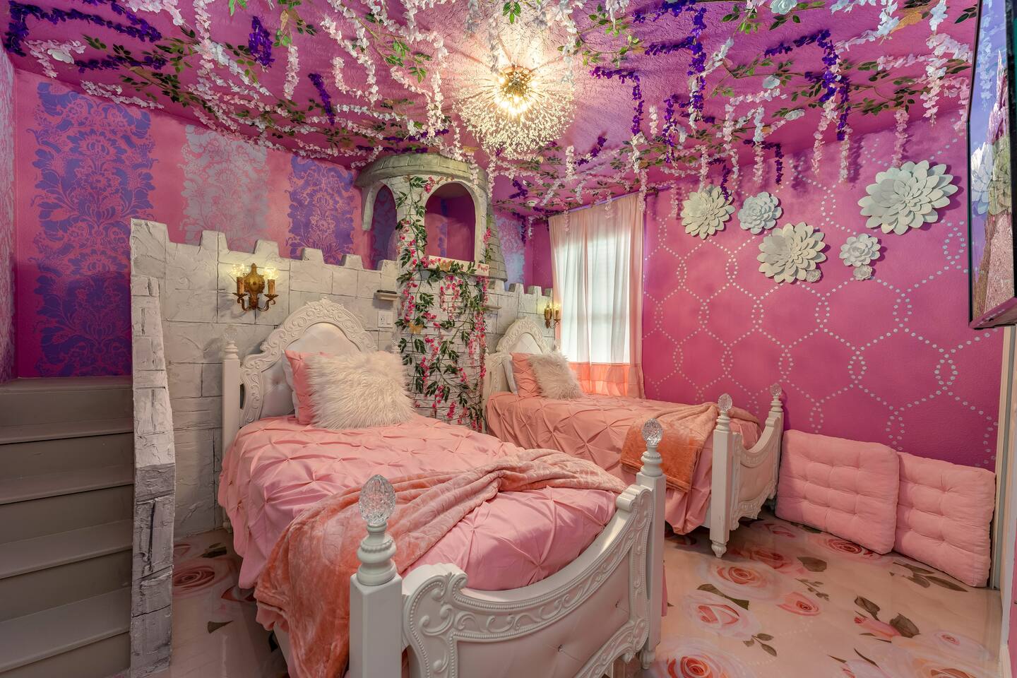 Princess room with castle tower, chandelier, and two twin beds
