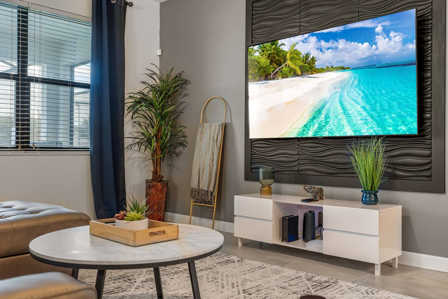 Living room wall-mounted TV with textured accent panel and console