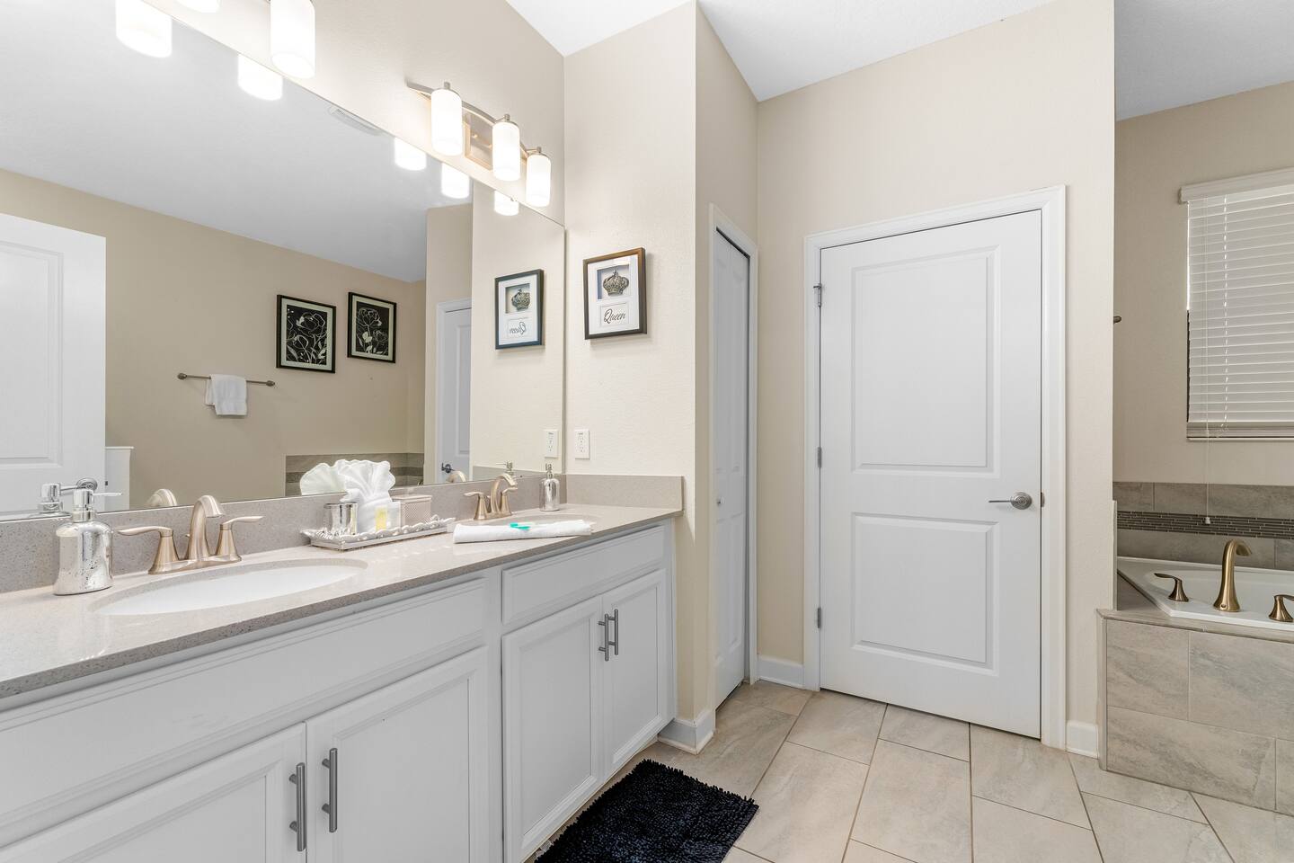Primary bathroom with double vanity and garden tub