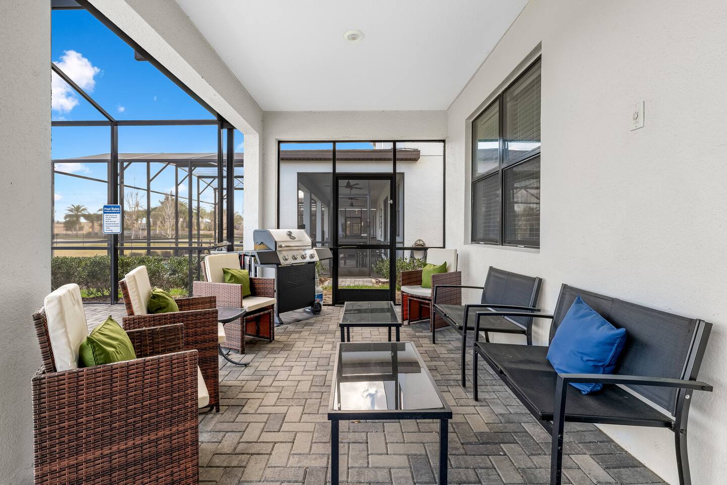 Covered lanai lounge seating beside the pool deck