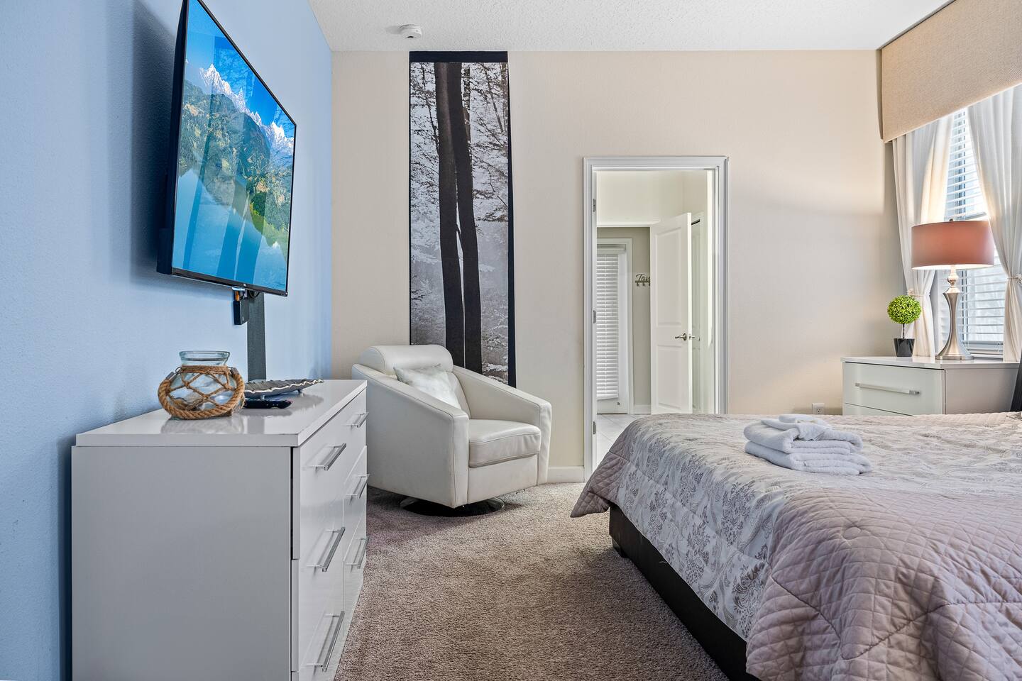 Relax in style with a sleek design, wall art, and a cozy reading nook!