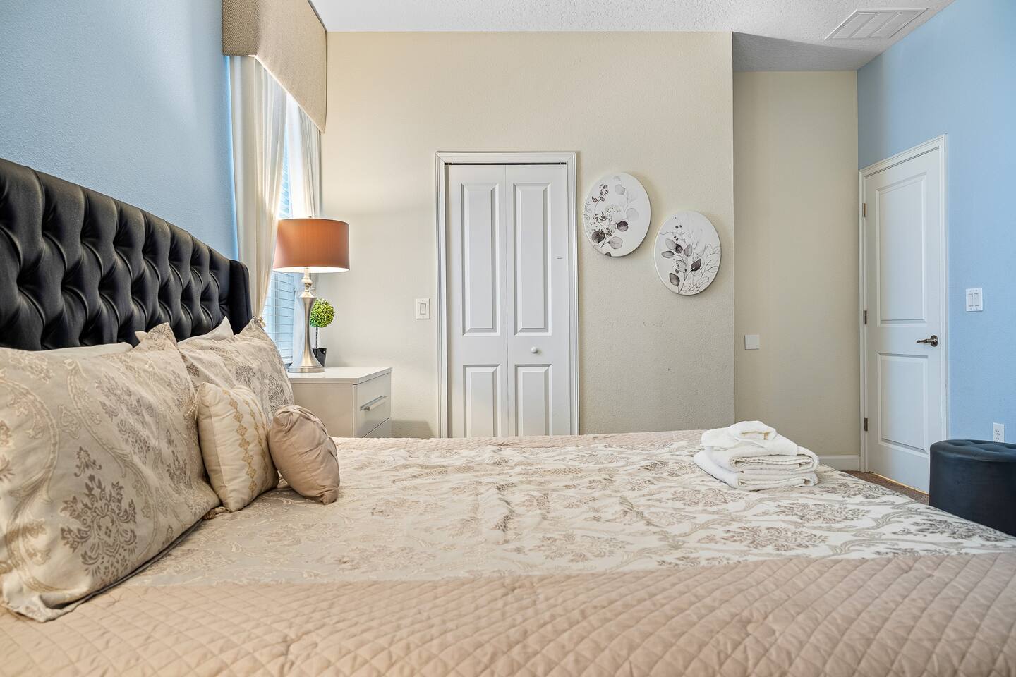 Serene retreat with plush bedding, ambient lighting, and tasteful decor!